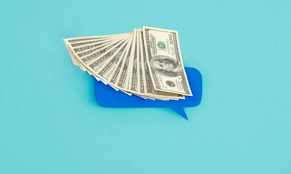 A blue background with an abstract illustration of a blue speech bubble and hundred dollar bills fanned out on top